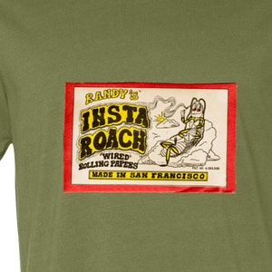 May include: A green t-shirt with a red and yellow rectangular patch that says "Randy's Insta Roach Wired Rolling Papers Made in San Francisco".