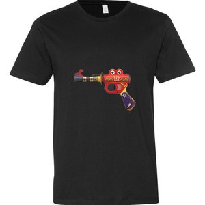 May include: A black t-shirt with a vintage toy rocket dart pistol printed on the front. The toy is red, yellow, blue, and silver with the words "Daisy Rocket Dart Pistol" printed on it.