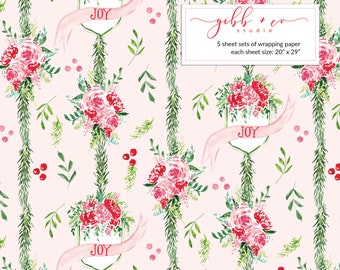 May include: Wrapping paper with a repeating pattern of pink roses, green foliage, and banners that say "JOY." The background is a light pink. The text in the image says "gibb + co studio" and "5 sheet sets of wrapping paper each sheet size: 20" x 29"."