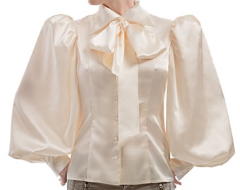Ivory cloose-fitting satin pussy-bow blouse.