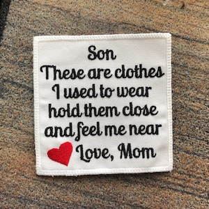 May include: White fabric patch with black embroidered text that reads "Son These are clothes I used to wear hold them close and feel me near Love, Mom" with a red embroidered heart.