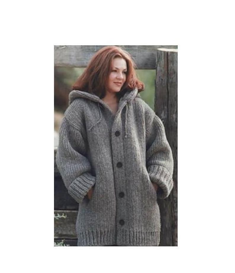 May include: A grey hooded cardigan sweater with a button fastening. The sweater is made from a thick, knitted fabric and has a relaxed fit.