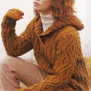 May include: A brown cable knit hooded sweater with a turtleneck collar. The sweater is made of a soft, warm yarn and has a relaxed fit.