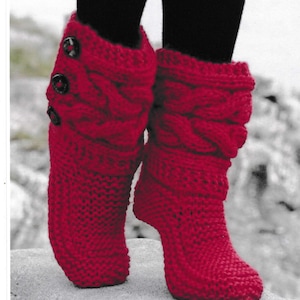 May include: Red knitted cable knit boot slippers with three black buttons on the side.