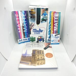 May include: A 3Doodler Create 3D printing pen kit including a box with product imagery, multiple packs of matte plastic refill strands in various colors, and a project book titled What Will You Create? Drawing with the 3Doodler.