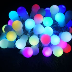 May include: A string of colourful LED fairy lights with round bulbs in various shades of blue, green, yellow, pink, and white.