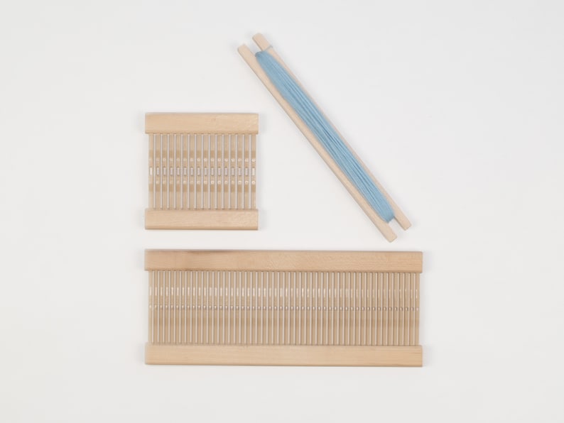 May include: Two wooden weaving looms with a light blue skein of yarn. The smaller loom is 10 inches wide and the larger loom is 18 inches wide.