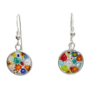 May include: A pair of silver dangle earrings with round, colorful mosaic glass pendants. The pendants feature a vibrant mix of small, flower-like designs in various colors, including red, blue, yellow, and white. The earrings have a simple, elegant design.