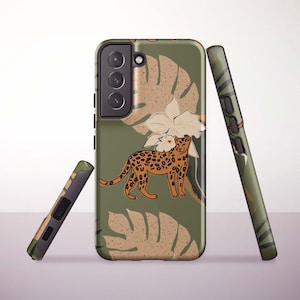 May include: A green phone case featuring a leopard illustration with brown spots, a white flower, and tan leaf designs. The case is shown with two additional cases, one leaning against the main case and another lying on its side.