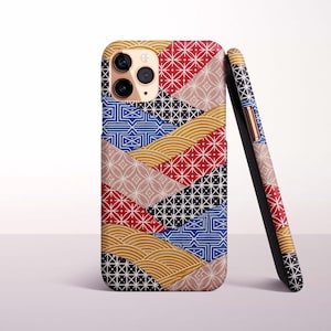 Könnte beinhalten: Eine Smartphone-Hülle mit einem mehrfarbigen Patchwork-Design und verschiedenen geometrischen Mustern in Rot, Blau, Schwarz und Gold. Die Hülle zeigt ein sich wiederholendes Motiv aus Sternen, Wellen und Linien sowie einen dreifachen Kameraausschnitt.