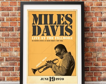 May include: A vintage poster advertising a Miles Davis concert at the Fillmore in New York City on June 19, 1970. The poster features a black and white image of Miles Davis playing a trumpet. The text on the poster is in black and white.