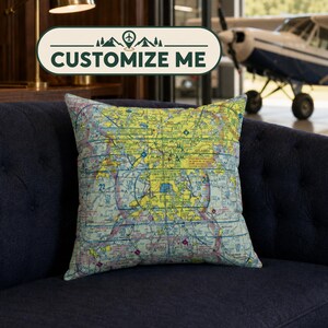 May include: A square throw cushion featuring a detailed aeronautical sectional chart print with yellow, blue, and white colour zones, complex grid lines, and various navigational text labels. The design covers the entire front surface of the cushion.