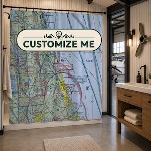 May include: A shower curtain featuring a detailed aviation sectional chart of the Daytona Beach area with various flight paths, navigation markers, and text. A prominent horizontal label in the center displays the text CUSTOMIZE ME.