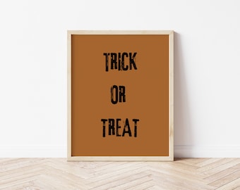 May include: A framed print with a brown background and the text "TRICK OR TREAT" in black.