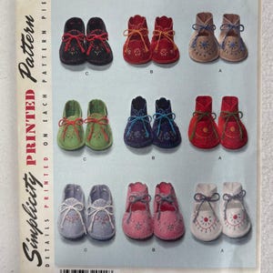 May include: Simplicity Printed Pattern 2867 featuring various pairs of baby booties in multiple colors, including red, blue, and pink. The pattern includes the text "ONE SIZE" and "VINTAGE '48 PATTERN".