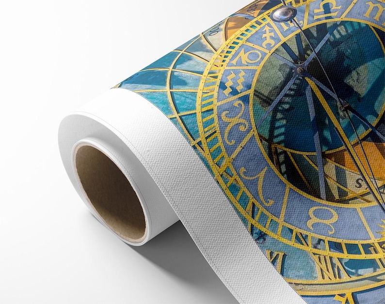May include: Rolled canvas print featuring a detailed depiction of an astronomical clock. The artwork showcases a blue and gold color scheme, with intricate zodiac symbols and Roman numerals. The canvas is rolled, revealing its white edge.