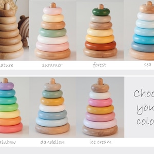 May include: Wooden stacking ring toys in various color schemes, including natural wood, pastel, and rainbow. Each toy has a wooden base and a series of rings that decrease in size. The text "Choose your color!" is also present.