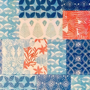 May include: A patchwork design featuring various blue and white patterns, including fish, leaves, and geometric shapes. The design is framed by a red and white border.