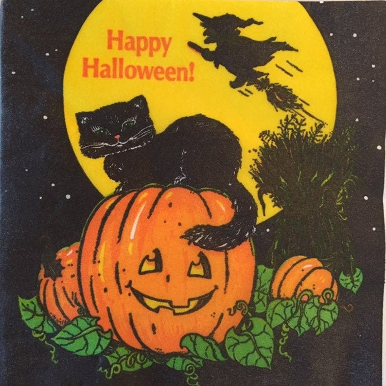 May include: A black cat sits on top of a carved orange pumpkin with a happy face. The pumpkin is surrounded by green leaves and vines. A witch flies on a broomstick in the background, with a yellow moon behind her. The text "Happy Halloween!" is written in black letters on the moon.