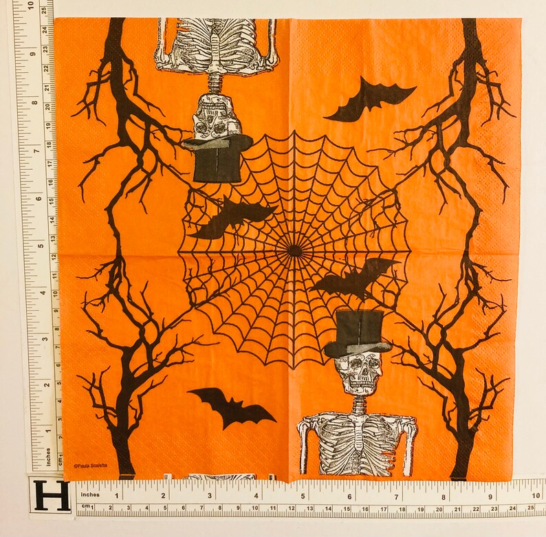 May include: Orange Halloween themed paper napkins with a black spiderweb design, black bats, and skeletons wearing top hats.