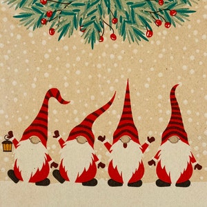 May include: Four red and white gnomes with white beards stand in a row against a brown background with a green leafy garland above them. The gnomes are wearing red and white pointed hats.