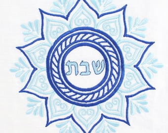 May include: Blue and light blue embroidered mandala with the Hebrew word "Shabbat" in the center.