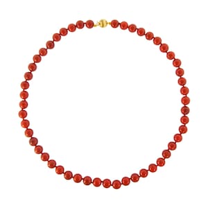 May include: A red coral bead necklace with a gold clasp.