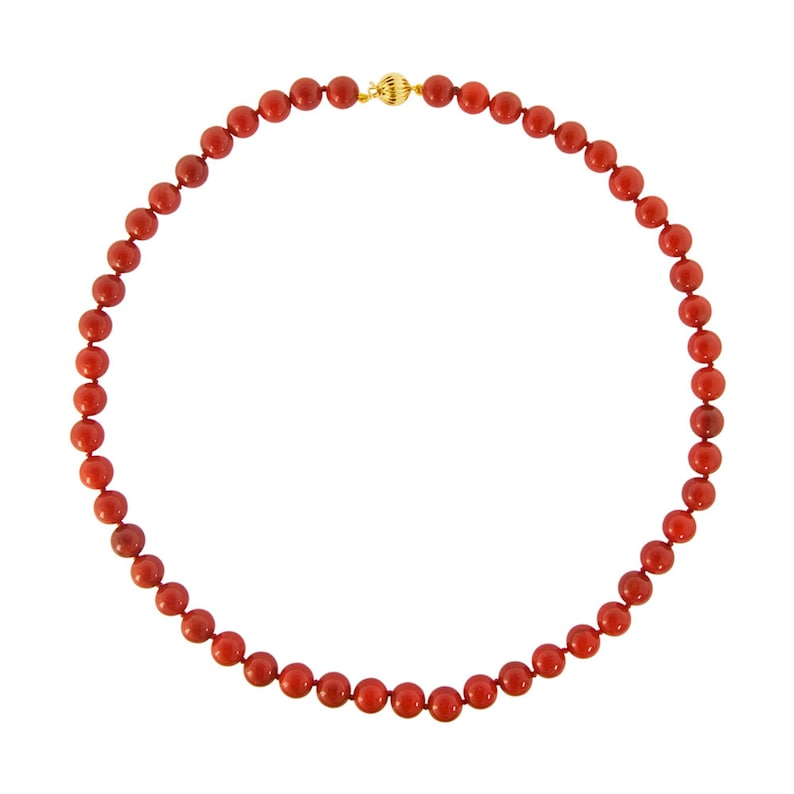 May include: A red coral bead necklace with a gold clasp.