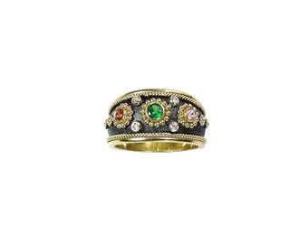 May include: A black and gold ring with a row of colorful gemstones. The ring has a textured band and a row of small gold beads around the gemstones.