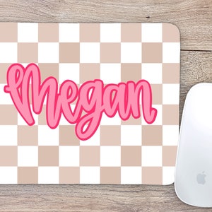 May include: A pink and white checkered mouse pad with the name "Megan" written in pink cursive.