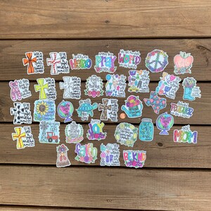 May include: A collection of colorful stickers with various designs and phrases. The stickers feature religious themes, inspirational quotes, and cute illustrations. Some of the phrases include "Let the beauty of what you love be what you do", "Trust in the Lord with all your heart", "Be Kind", and "Girl Mom".