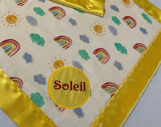 Rainbow Muslin front, backed and edged with yellow silky fabric. This is travel size lovey 20x20, perfect baby shower gift