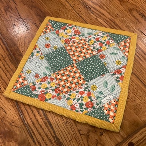 Homemade quilted pot holder, This hot pad is made with a fun variety of fabric prints, measures approximately 8x8