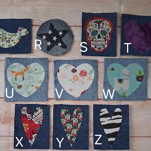 May include: A collection of denim patches with various fabric appliqu&eacute;s. Designs include a bird, star, sugar skull, purple heart, fox, floral heart, llama, and hearts with skull, cherry, and zebra patterns. Each patch is a unique design.