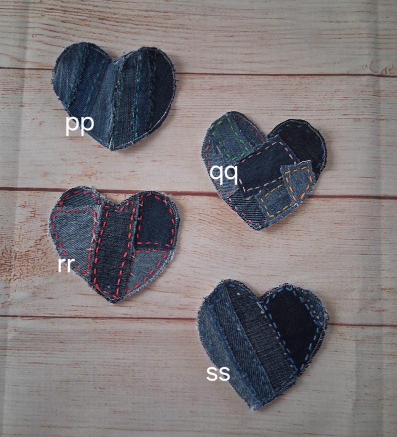 May include: Four denim heart-shaped patches with visible stitching. Each heart is made from different shades of blue denim. The patches are labeled with the letters "pp", "qq", "rr", and "ss".