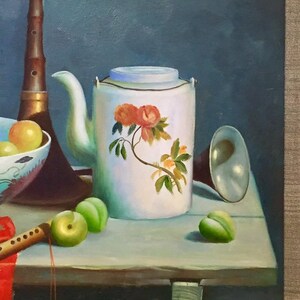 May include: A still life painting featuring a white teapot with a floral design, a bowl of fruit, a musical instrument, and other objects on a wooden table.