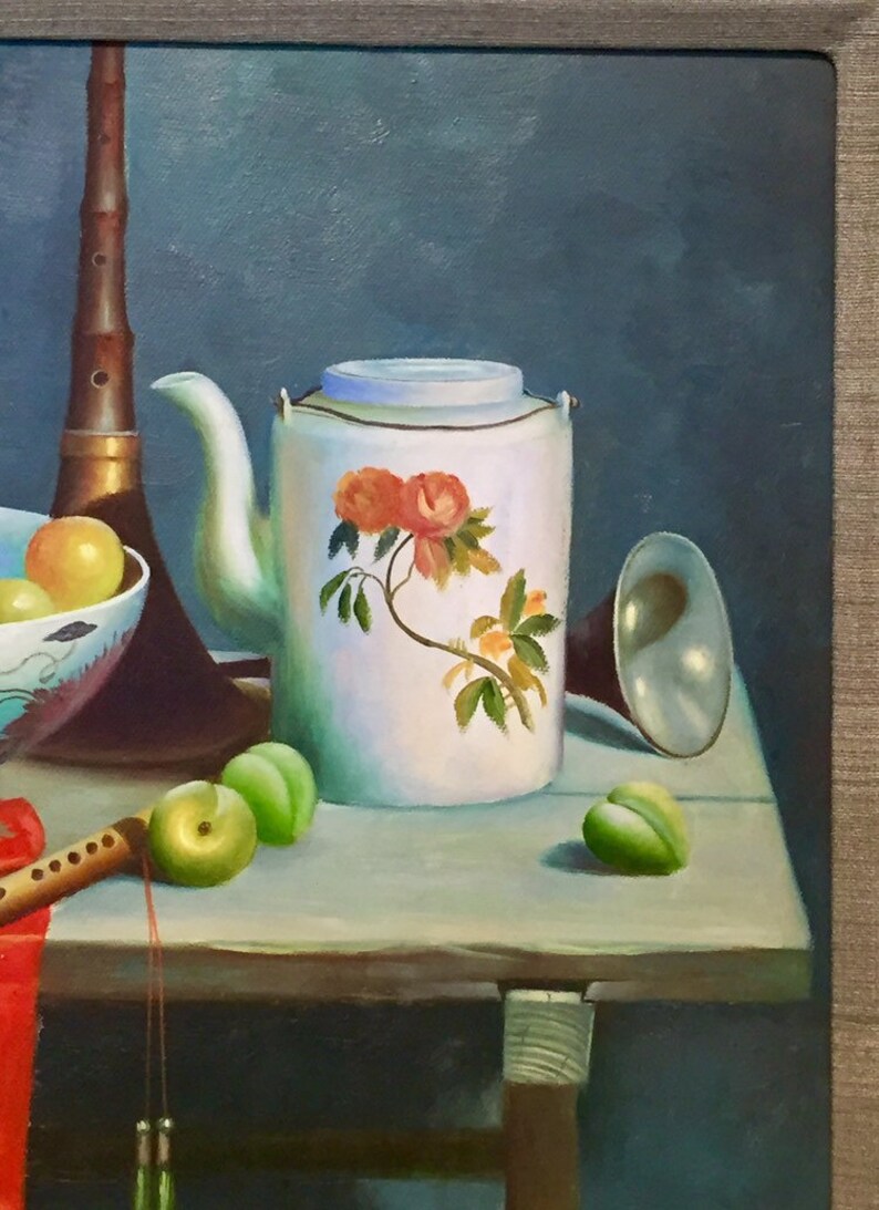 May include: A still life painting featuring a white teapot with a floral design, a bowl of fruit, a musical instrument, and other objects on a wooden table.