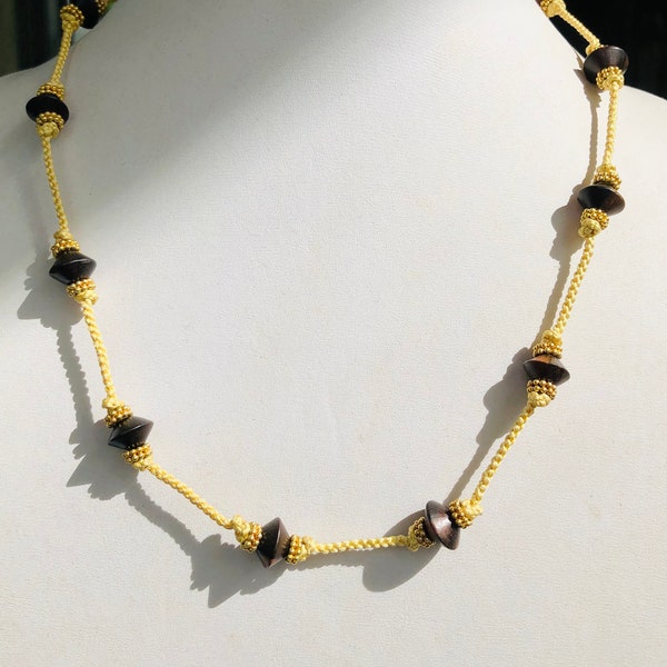 Guy Jewelry!! Bicone Tigerwood beads flanked by Vermeil Daisy Spacers. Knotted onto pale yellow hand-loomed Kumihimo cord. 20” L