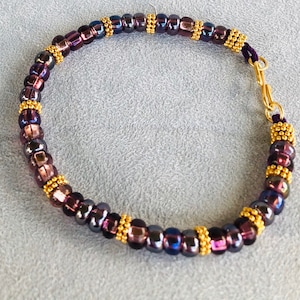 Bangle Bracelet Plum-colored Czech beads interspersed with golden Vermeil Daisy spacers. Regal color, elegant styling. Size 7-3/4”