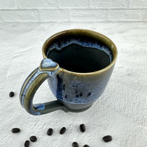 Heart thumb rest mug, coffee mug with heart, wheel thrown ceramic coffee mug, black mug with flowing blue rim
