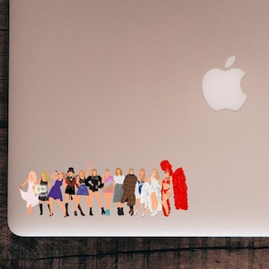May include: A sticker featuring a group of stylized figures in various outfits. The figures are depicted in a range of colors, including white, black, blue, and red. The sticker is placed on a silver laptop.