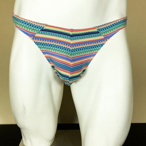May include: Multicoloured striped men's underwear with a geometric pattern. The underwear is made of a soft, stretchy fabric and has a low rise cut.