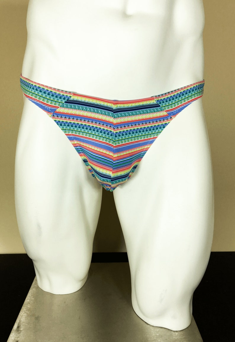 May include: Multicoloured striped men's underwear with a geometric pattern. The underwear is made of a soft, stretchy fabric and has a low rise cut.