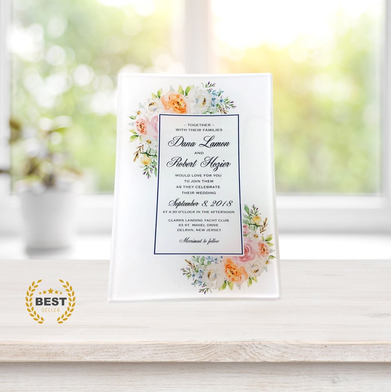 May include: A white wedding invitation with floral accents. The invitation announces the wedding of Dana Lamon and Robert Hozier on September 8, 2018, at 4:30 PM at Clarks Landing Yacht Club in Delran, New Jersey.