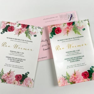 May include: A white invitation with pink and red floral border. The text reads "The Board of Directors of the Atlanta Opera invites you to join us in honoring Rae Weimer. Wednesday, April 17, 2019. 6:30 pm Cocktail Reception. 7:00 pm Presentation and Remarks. Cherokee Town and Country Club, 155 West Paces Ferry Road, Atlanta, Georgia."