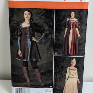 May include: Simplicity sewing pattern 1773 H5 for dresses with square necklines, lace-up bodices, and long sleeves. The envelope displays three variations of the garment in brown, red, and cream colors, including sizing information for U.S. 6-14.