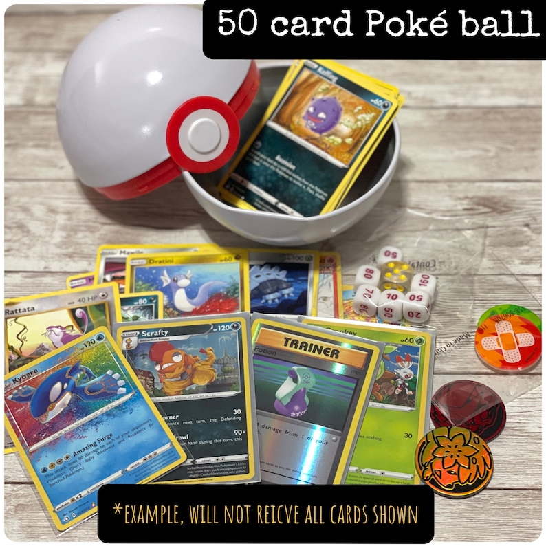 May include: A white and red Pok&eacute; Ball container with a selection of Pok&eacute;mon trading cards, dice, and game tokens. The text "50 card Pok&eacute; ball" is visible. The cards feature various Pok&eacute;mon characters.