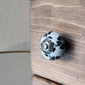 May include: A rustic wooden sign with the text "Welcome to our home" in white lettering. The sign features a distressed finish and a simple, inviting design, perfect for front door decor.