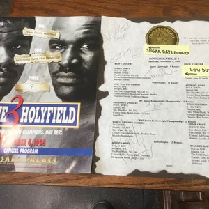 May include: Official program from the Bowe vs. Holyfield III boxing match at Caesars Palace on November 4, 1995. The program features images of the boxers and event details, including signatures.