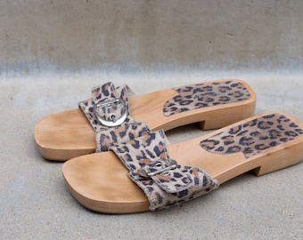 Charles David jaguar-print wooden slippers—striking and laid back style.